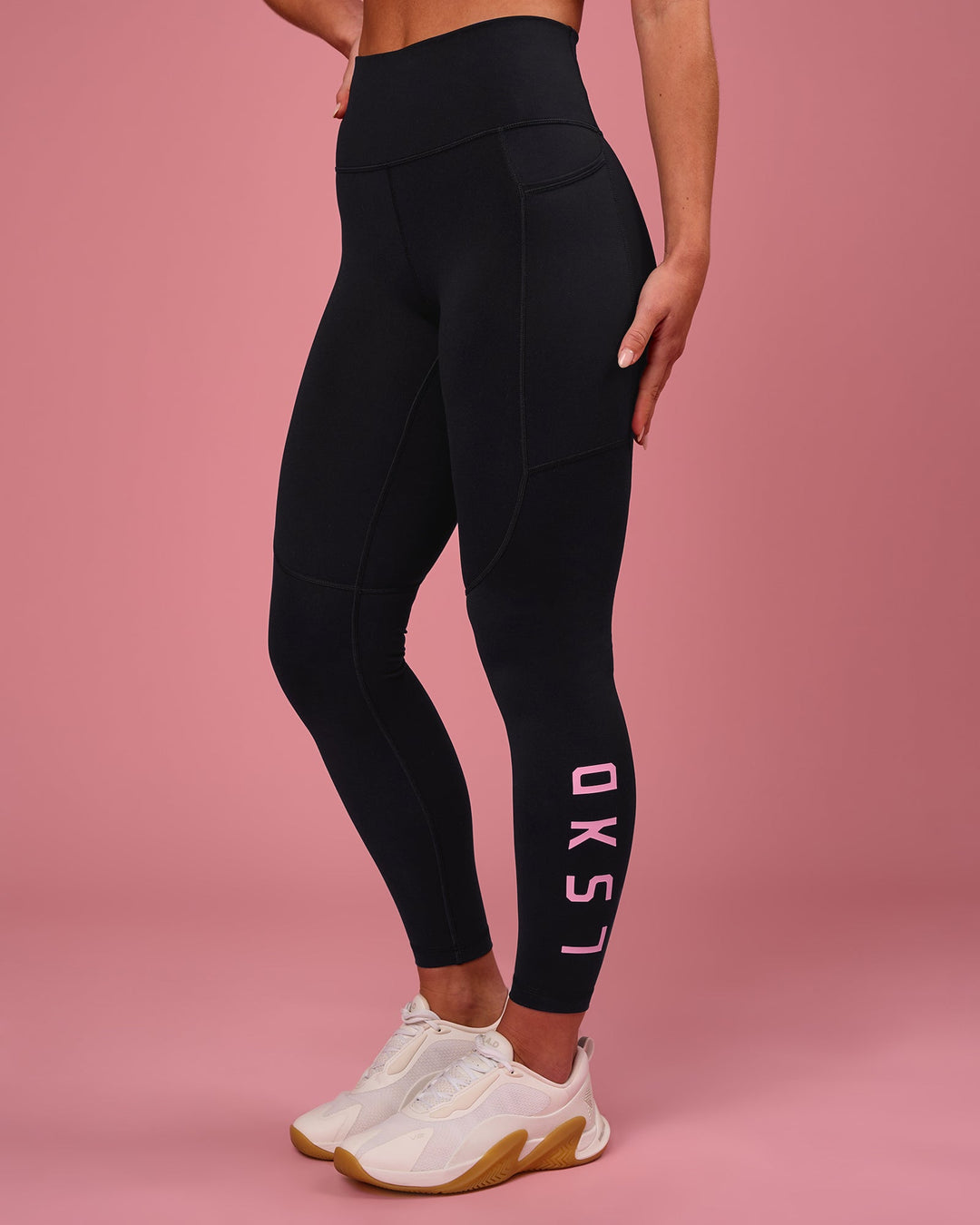 Woman wearing Rep Ultra High-Rise 7/8 Legging Pockets - Black-Pink Rose | Model:Issy | Size:XS - view 1
