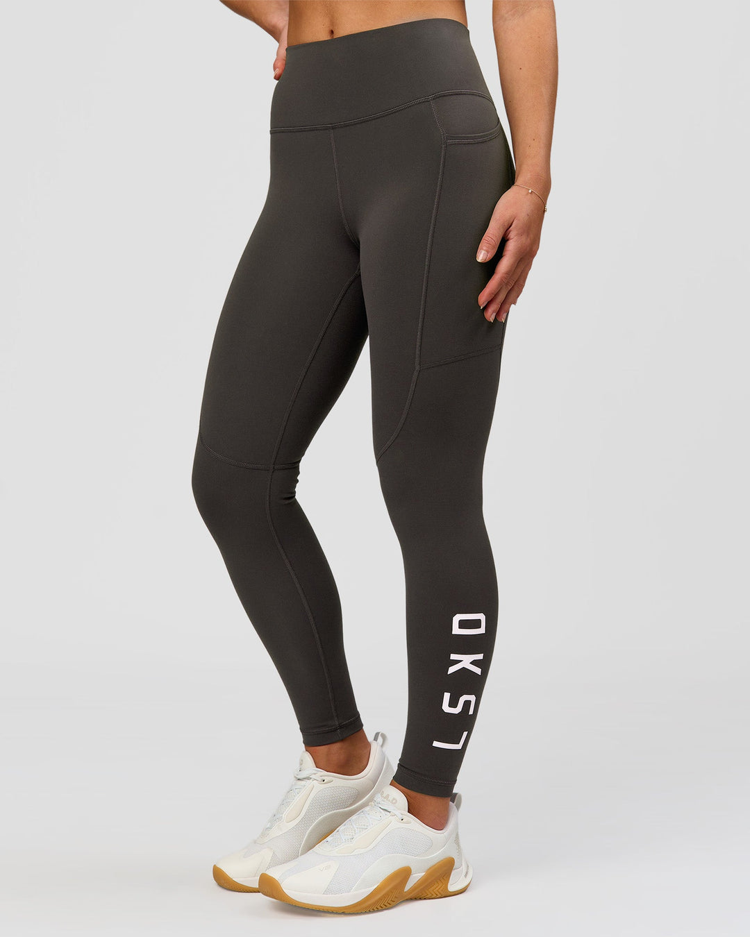Woman wearing Rep Ultra High-Rise 7/8 Legging Pockets - Onyx-white | Model:Issy | Size:XS - view 3