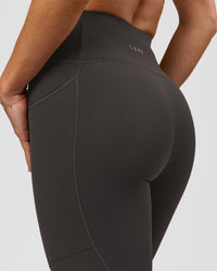 Woman wearing Rep Ultra High-Rise 7/8 Legging Pockets - Onyx-white | Model:Issy | Size:XS | Thumbnail Index: 6