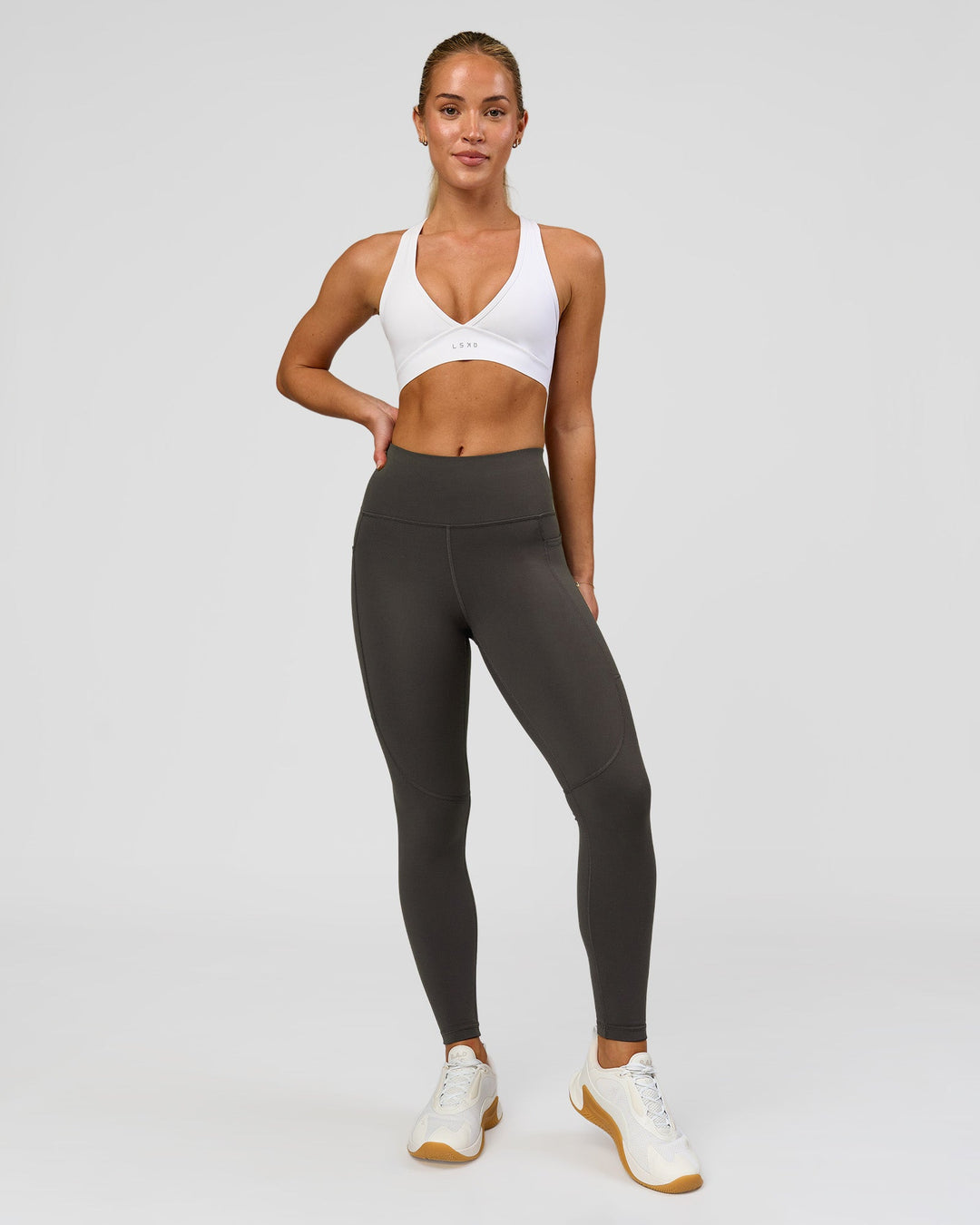 Woman wearing Rep Ultra High-Rise 7/8 Legging Pockets - Onyx-white | Model:Issy | Size:XS - view 8