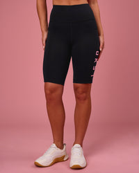 Woman wearing Rep Ultra High-Rise 9" Short Pockets - Black-Pink Rose | Model:Issy | Size:XS | Thumbnail Index: 4