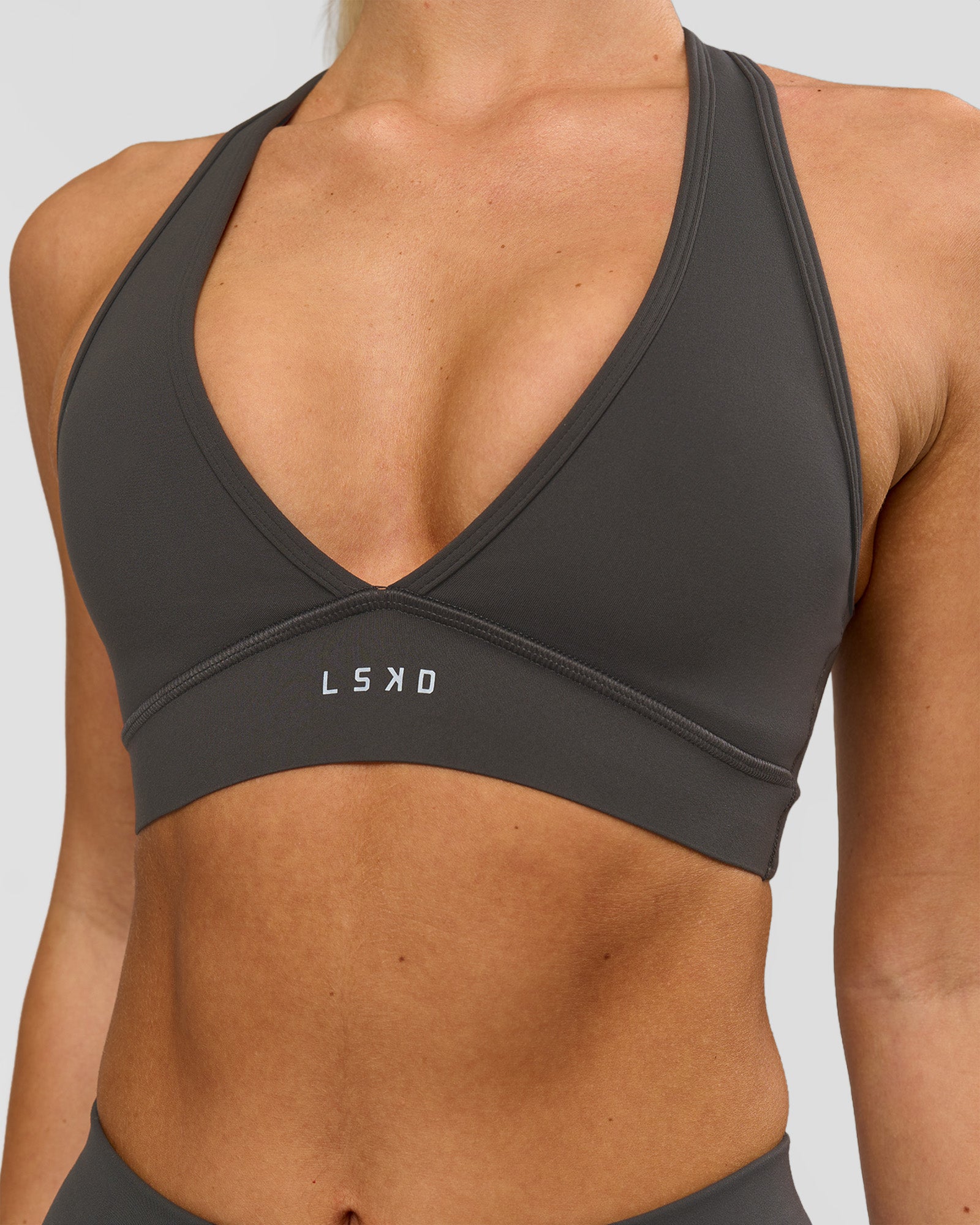 Woman wearing Stamina Sports Bra - Onyx | Model:Issy | Size:XS