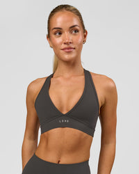 Woman wearing Stamina Sports Bra - Onyx | Model:Issy | Size:XS | Thumbnail Index: 2