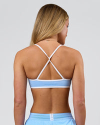 Woman wearing Strong is Beautiful Sports Bra - Open Air-White | Model:Issy | Size:XS | Thumbnail Index: 1