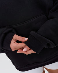 Woman wearing Tonal Legacy Boxy Hoodie - Black-Black | Model:Issy | Size:XS | Thumbnail Index: 12