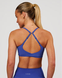 Woman wearing Twist Sports Bra - Power Cobalt | Model:Issy | Size:XS | Thumbnail Index: 2