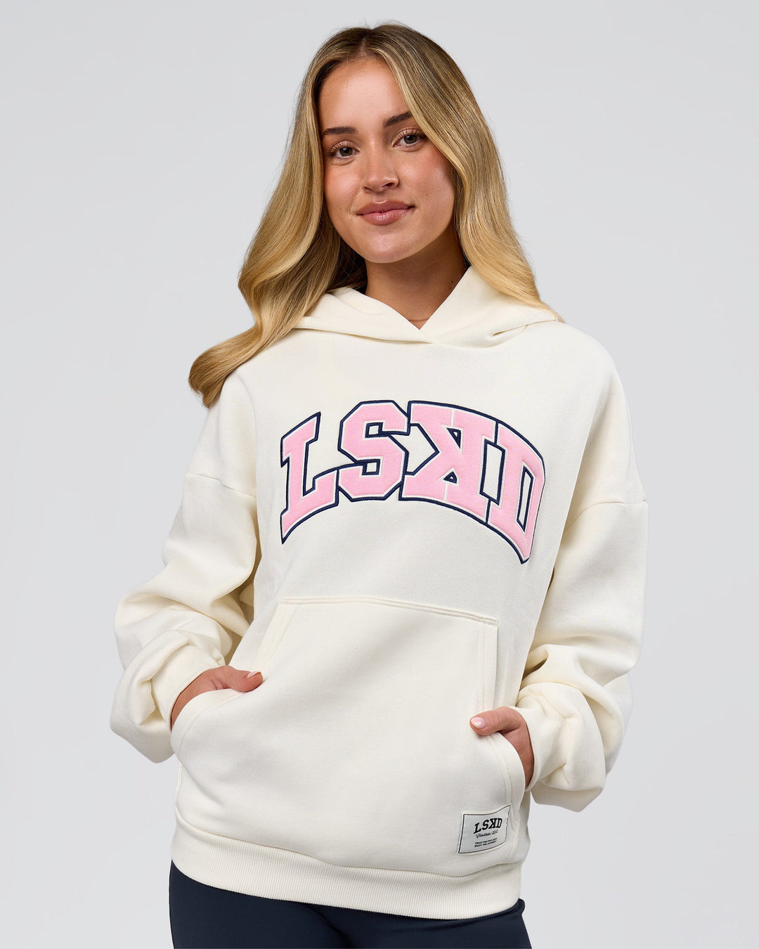 Woman wearing Varsity Boxy Hoodie - Off White-Pink Rose | Model:Issy | Size:XS - view 12