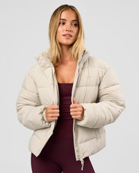 Woman wearing Go-To Puffer Jacket - Shale Beige | Model:Izzy | Size:XS | Thumbnail Index: 0