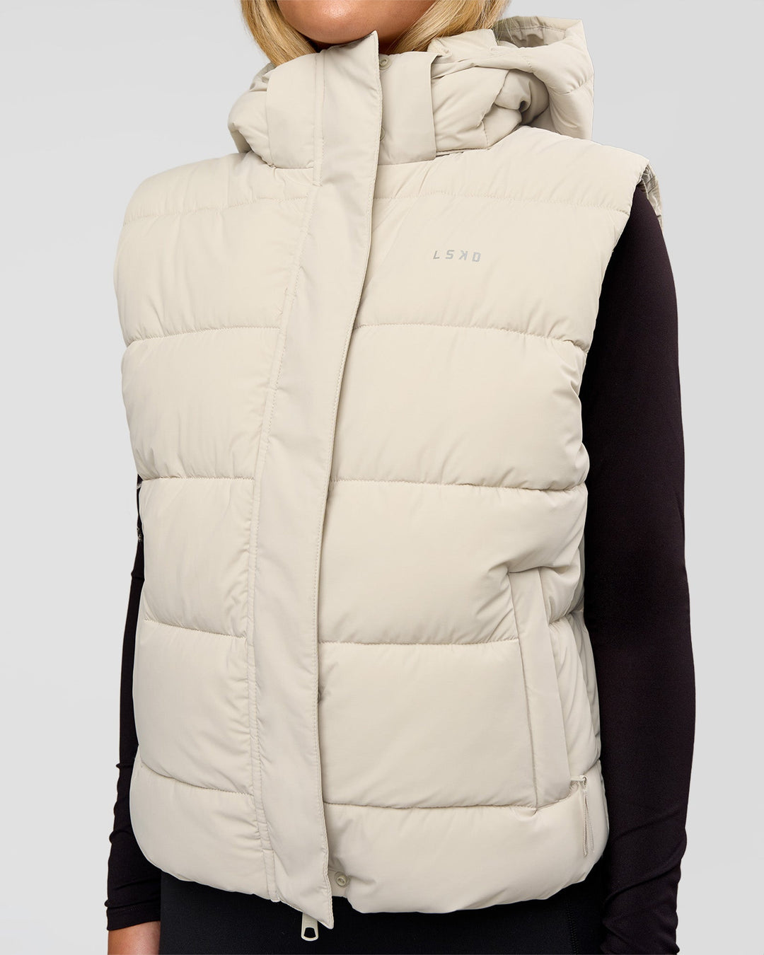 Woman wearing Go-To Puffer Vest - Shale Beige | Model:Izzy | Size:XS - view 1