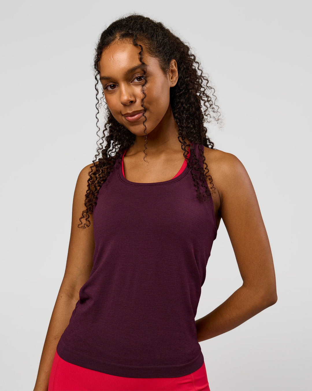 Woman wearing AeroFLX+ Seamless Tank - Cherry Lacquer/Cherry Lacquer | Model:Jordan | Size:XS - view 1