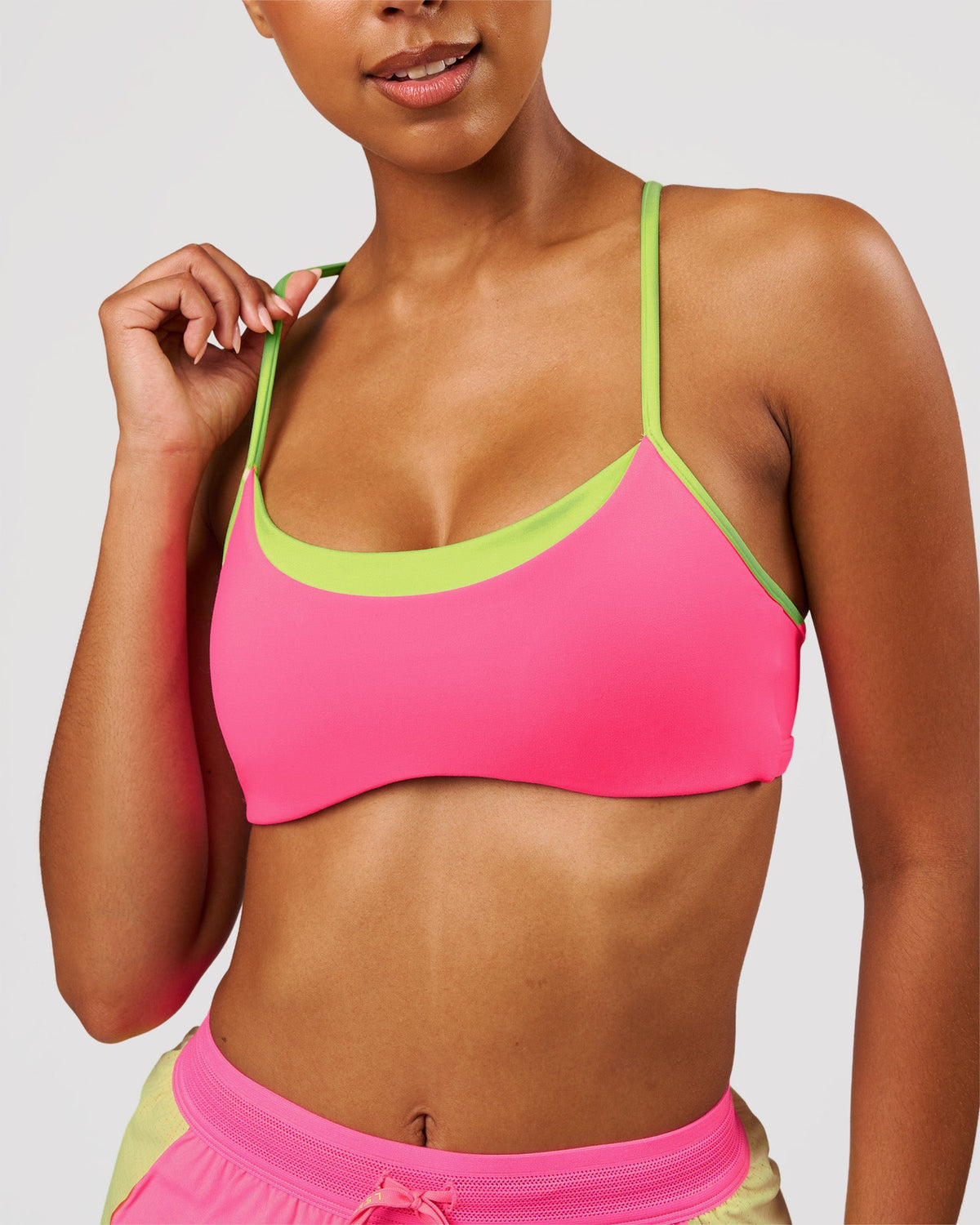 Woman wearing Tempo Sports Bra - Sugar Plum-Lime Glo | Model:Jordan | Size:XS