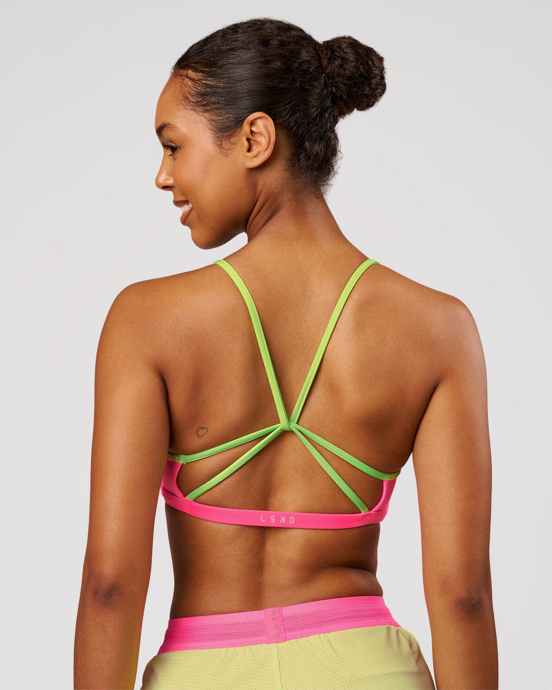 Woman wearing Tempo Sports Bra - Sugar Plum-Lime Glo | Model:Jordan | Size:XS - view 3