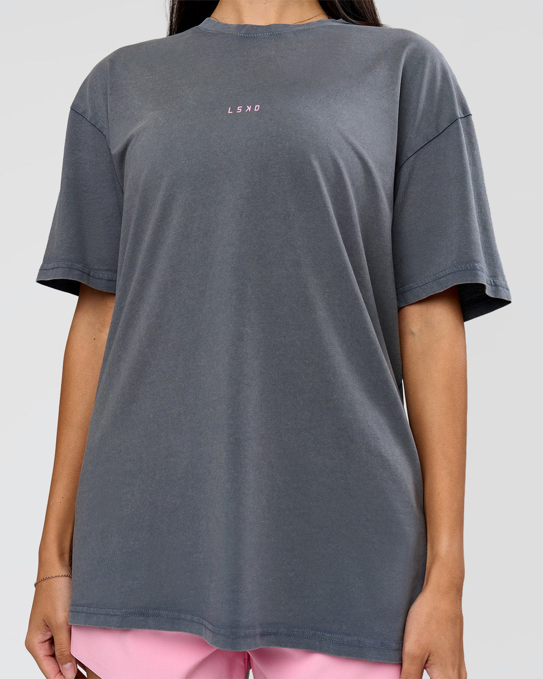 Woman wearing Built On Values FLXCotton Oversized Tee - Dark Storm Washed-Pink Rose | Model:Rhiley | Size:XS