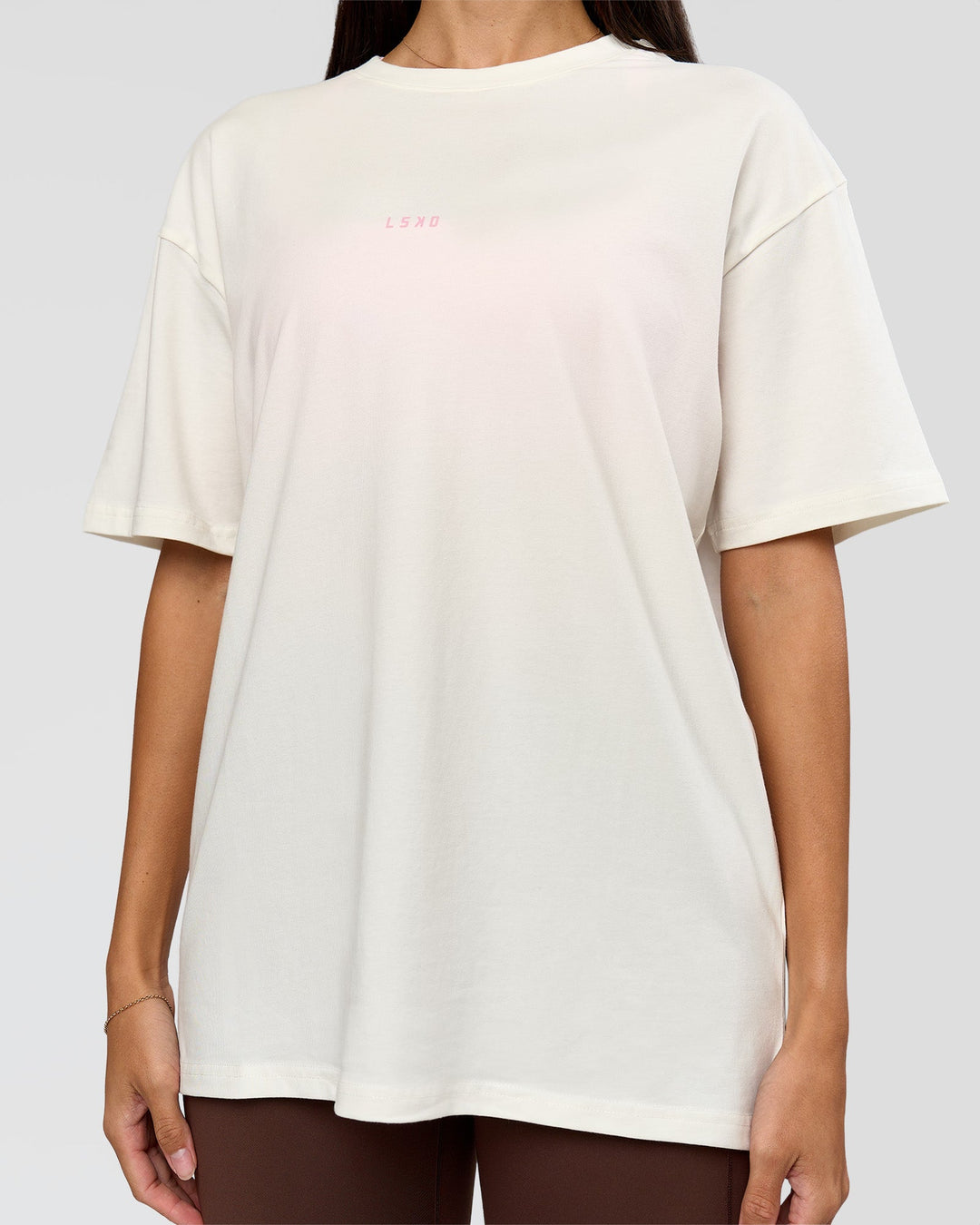 Woman wearing Built On Values FLXCotton Oversized Tee - Off White-Pink Rose | Model:Rhiley | Size:XS