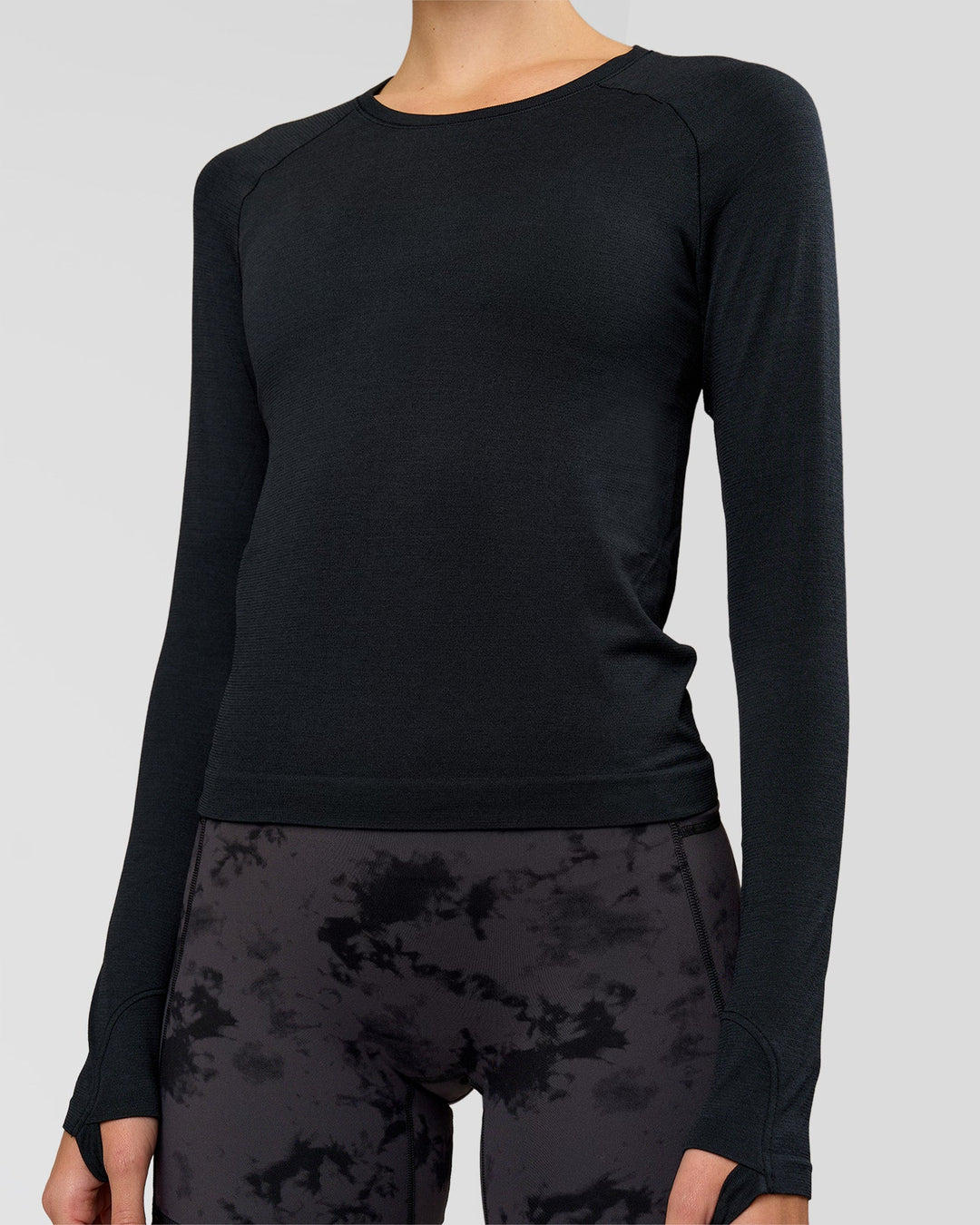 Woman wearing AeroFLX+ Seamless Long Sleeve Tee - Black Marl | Model:Taneisha | Size:XS - view 2
