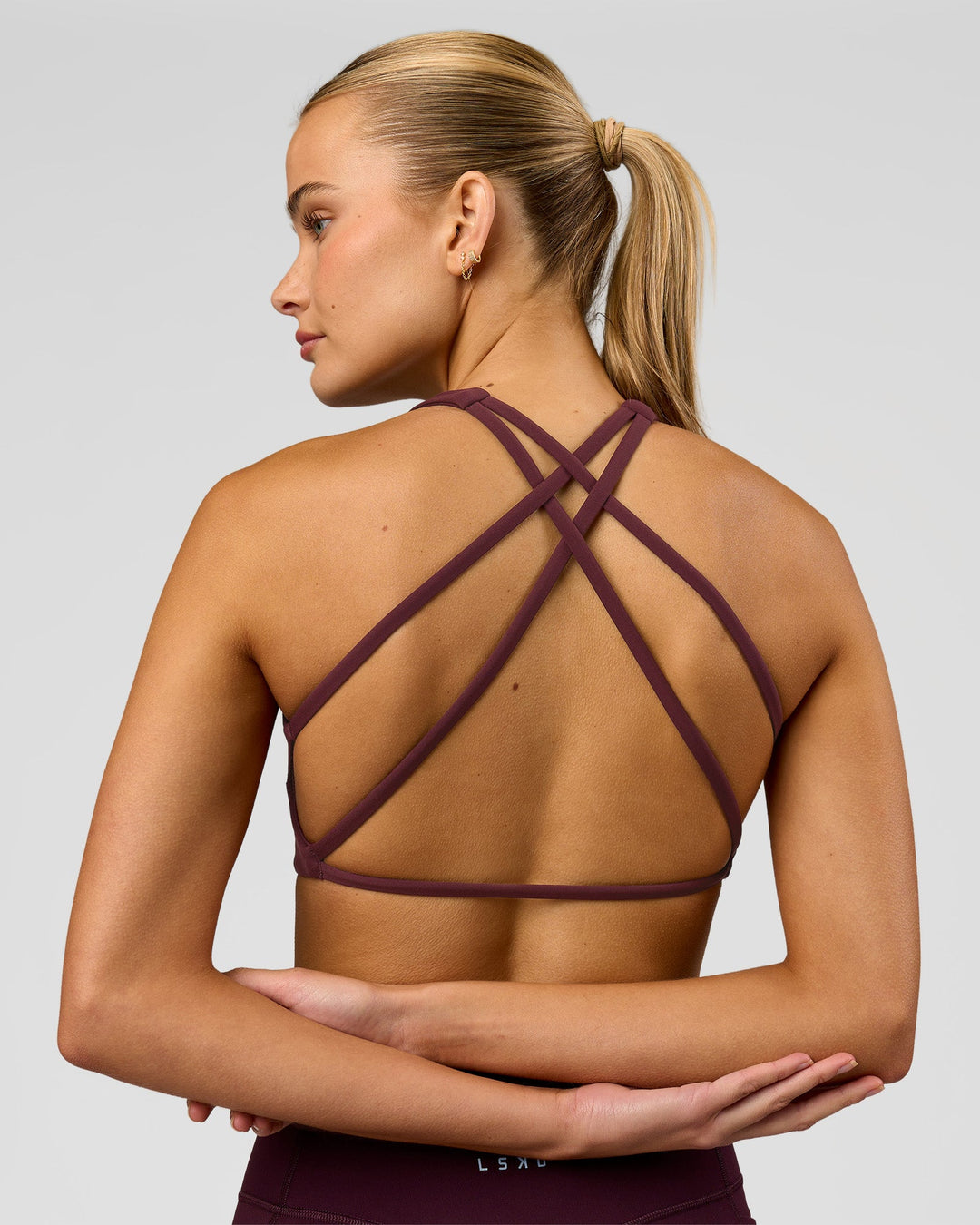 Woman wearing Aspire Sports Bra - Cherry Lacquer | Model:Taneisha | Size:XS - view 1