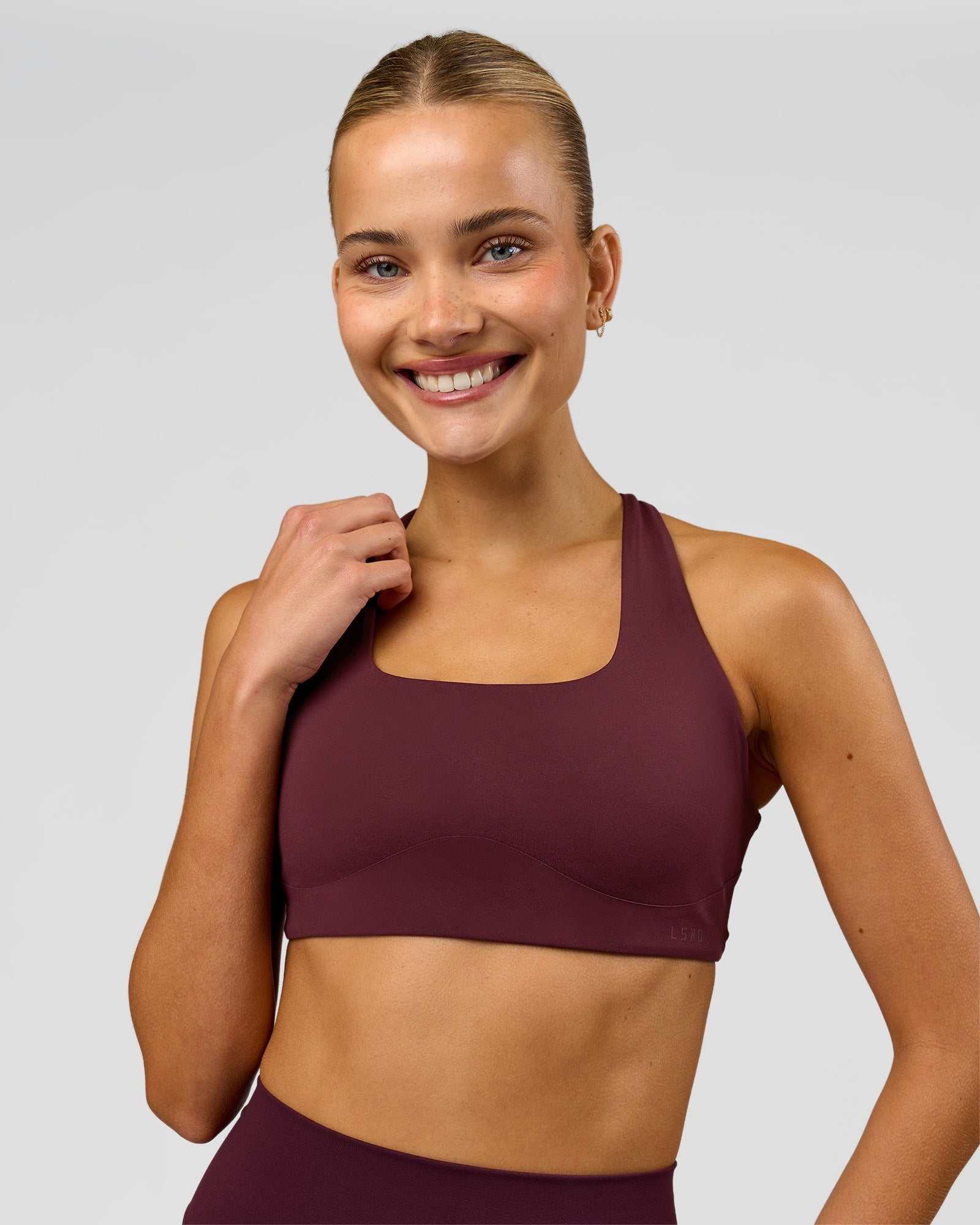 Woman wearing Aspire Sports Bra - Cherry Lacquer | Model:Taneisha | Size:XS