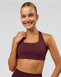 Woman wearing Aspire Sports Bra - Cherry Lacquer | Model:Taneisha | Size:XS | Thumbnail Index: 1