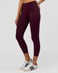 Woman wearing Fusion High-Rise 7/8 Legging Pockets - Cherry Lacquer | Model:Taneisha | Size:XS | Thumbnail Index: 0