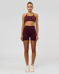 Woman wearing Fusion V-Contour Ultra High-Rise 4" Short Pockets - Cherry Lacquer | Model:Taneisha | Size:XS | Thumbnail Index: 2