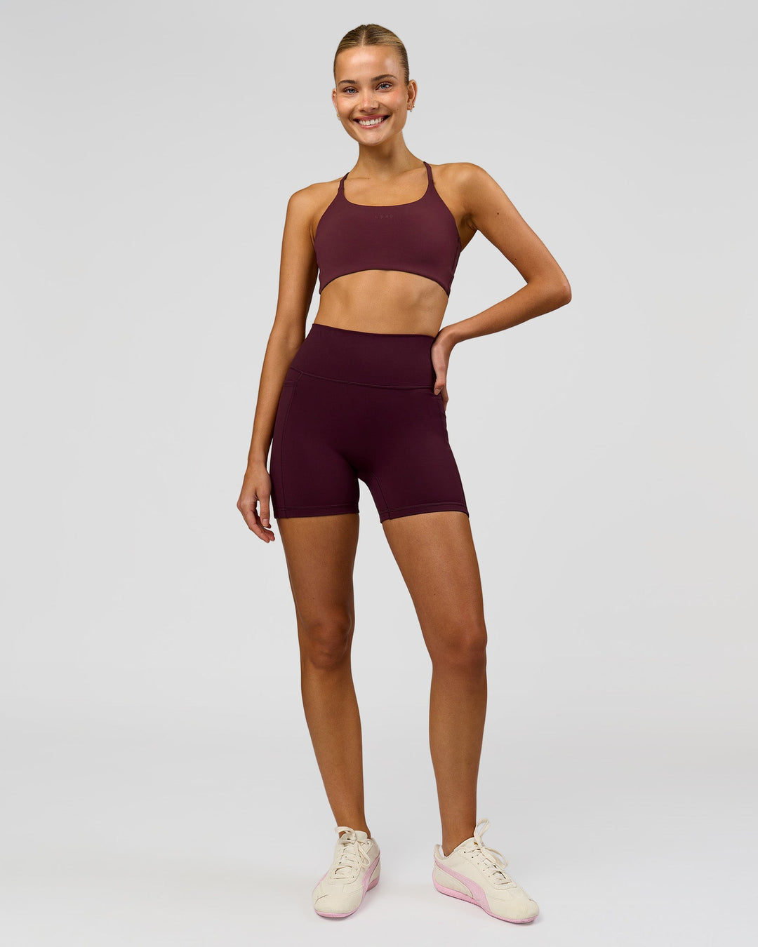 Woman wearing Fusion V-Contour Ultra High-Rise 4" Short Pockets - Cherry Lacquer | Model:Taneisha | Size:XS - view 5