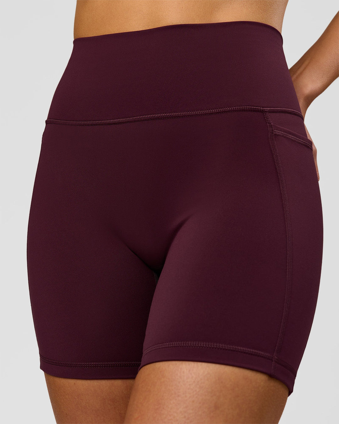 Woman wearing Fusion V-Contour Ultra High-Rise 6" Short Pockets - Cherry Lacquer | Model:Taneisha | Size:XS - view 1