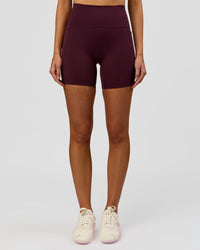 Woman wearing Fusion V-Contour Ultra High-Rise 6" Short Pockets - Cherry Lacquer | Model:Taneisha | Size:XS | Thumbnail Index: 4