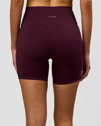 Woman wearing Fusion V-Contour Ultra High-Rise 6" Short Pockets - Cherry Lacquer | Model:Taneisha | Size:XS | Thumbnail Index: 1