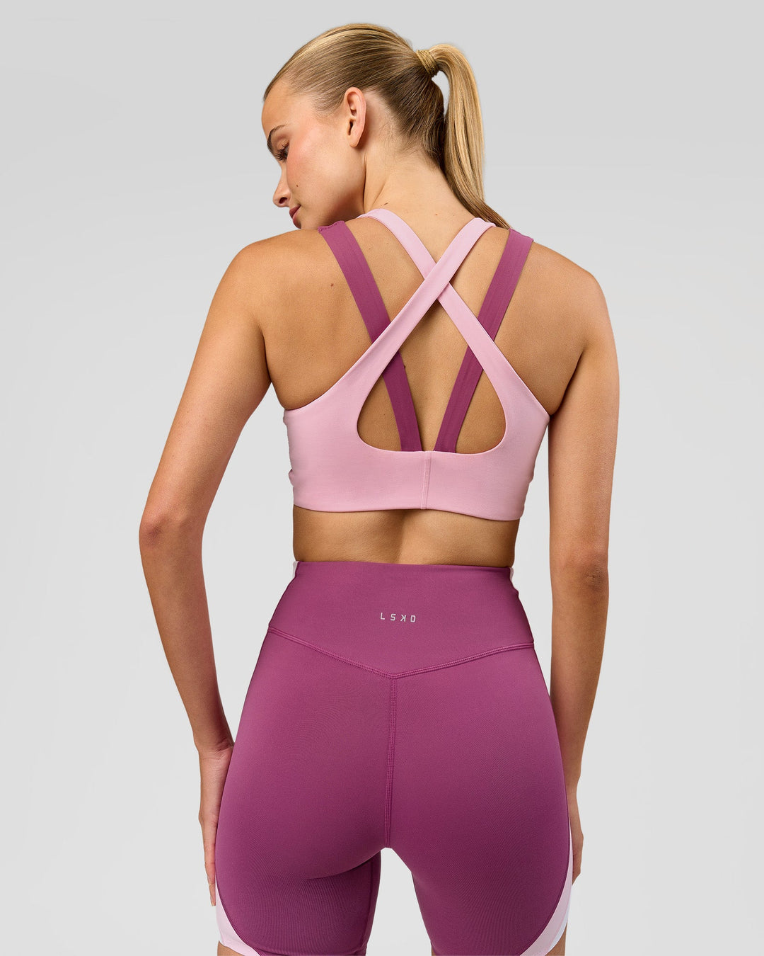 Woman wearing Stamina Layered Sports Bra - Boysenberry-Pink Rose | Model:Taneisha | Size:XS - view 6