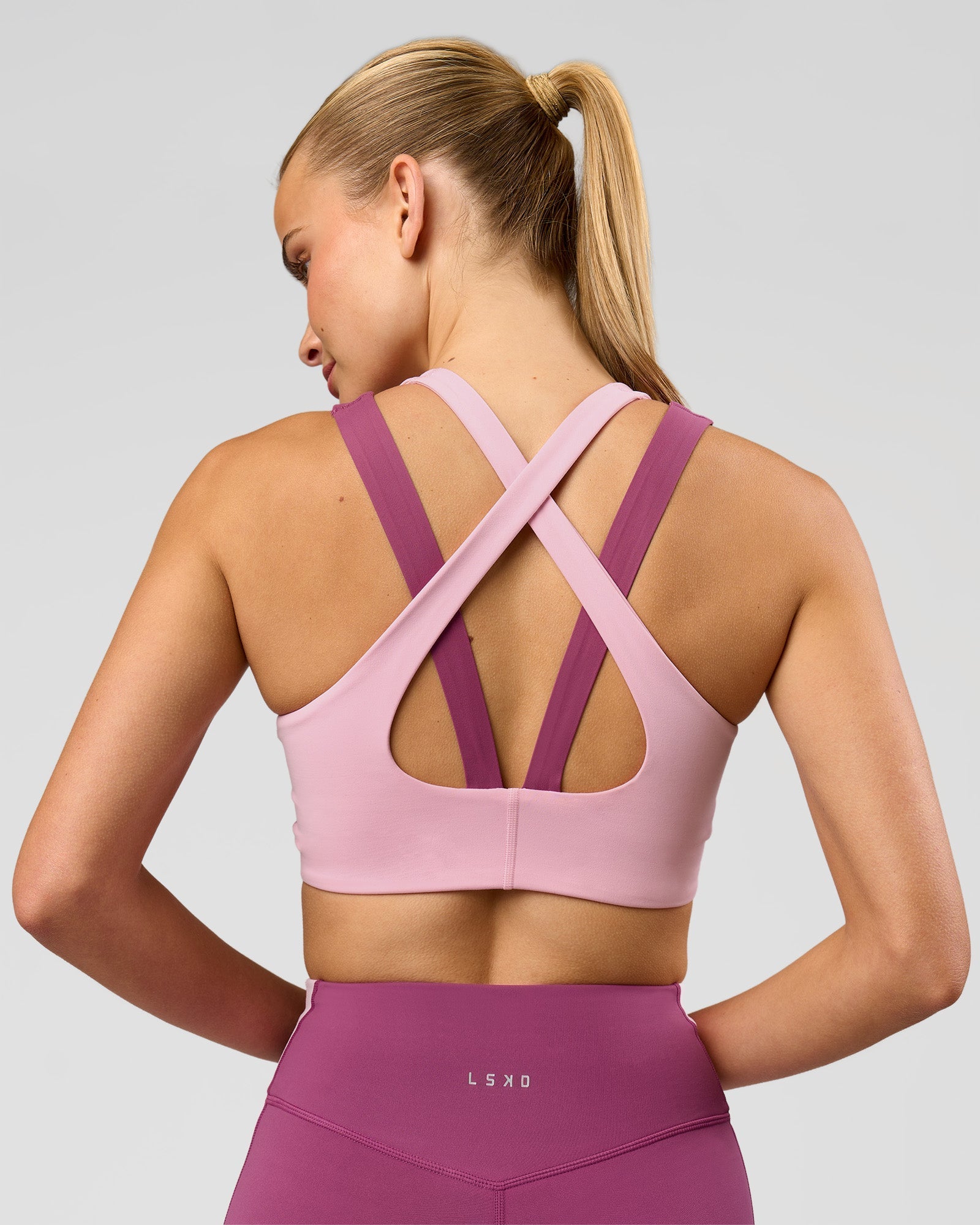 Woman wearing Stamina Layered Sports Bra - Boysenberry-Pink Rose | Model:Taneisha | Size:XS