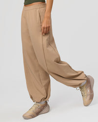 Woman wearing Stitch Up Track Pant - Warm Smoke | Model:Taneisha | Size:XS | Thumbnail Index: 0