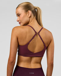 Woman wearing Twist Sports Bra - Cherry Lacquer | Model:Taneisha | Size:XS | Thumbnail Index: 0