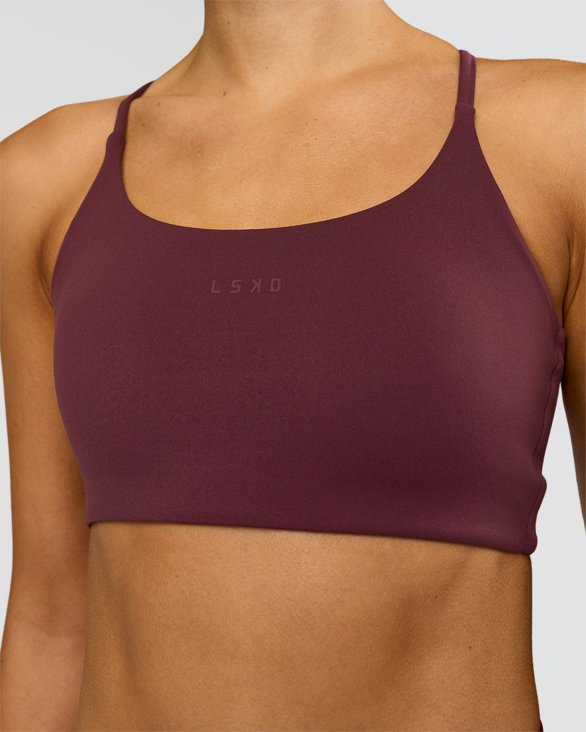 Woman wearing Twist Sports Bra - Cherry Lacquer | Model:Taneisha | Size:XS