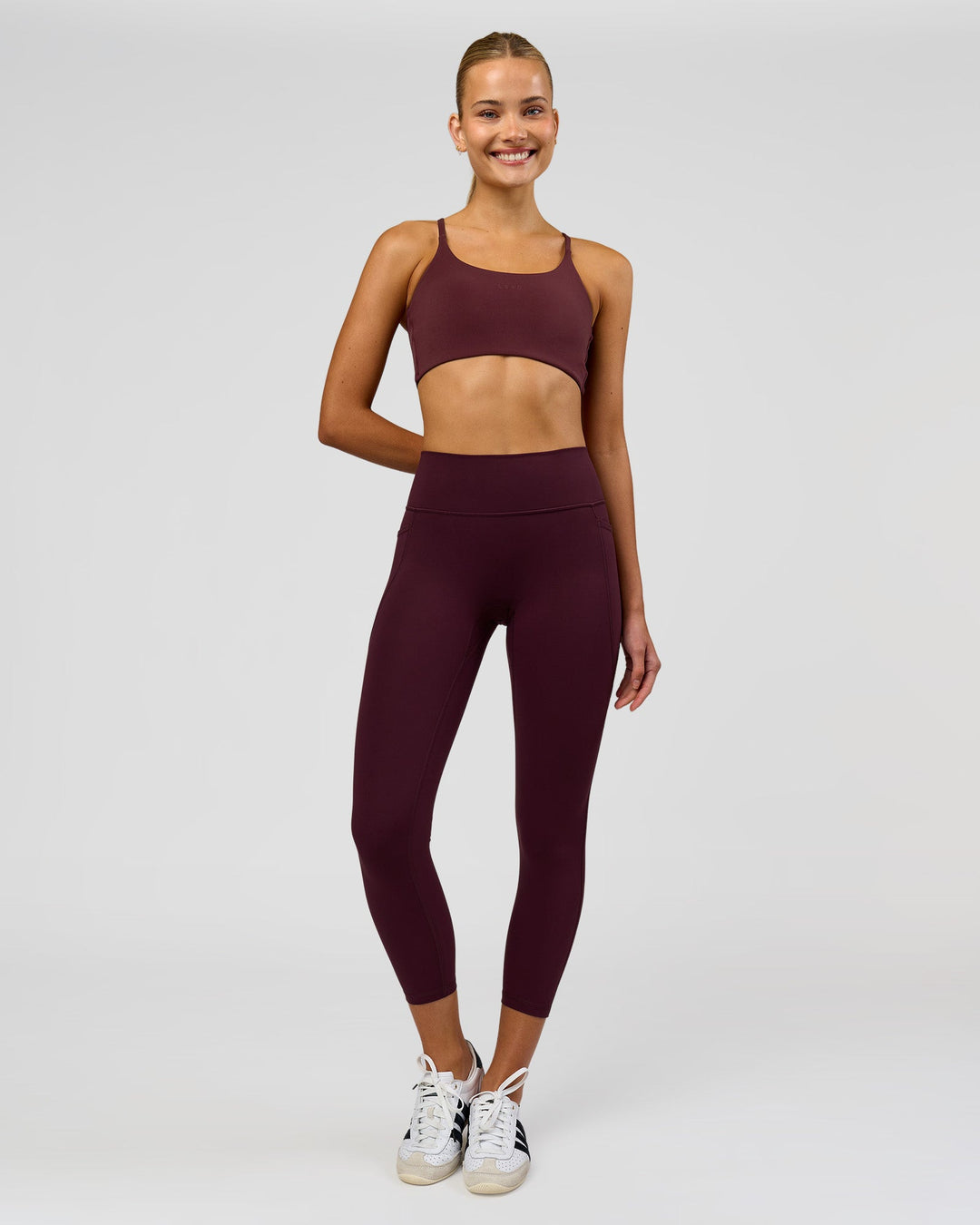 Woman wearing Twist Sports Bra - Cherry Lacquer | Model:Taneisha | Size:XS - view 3