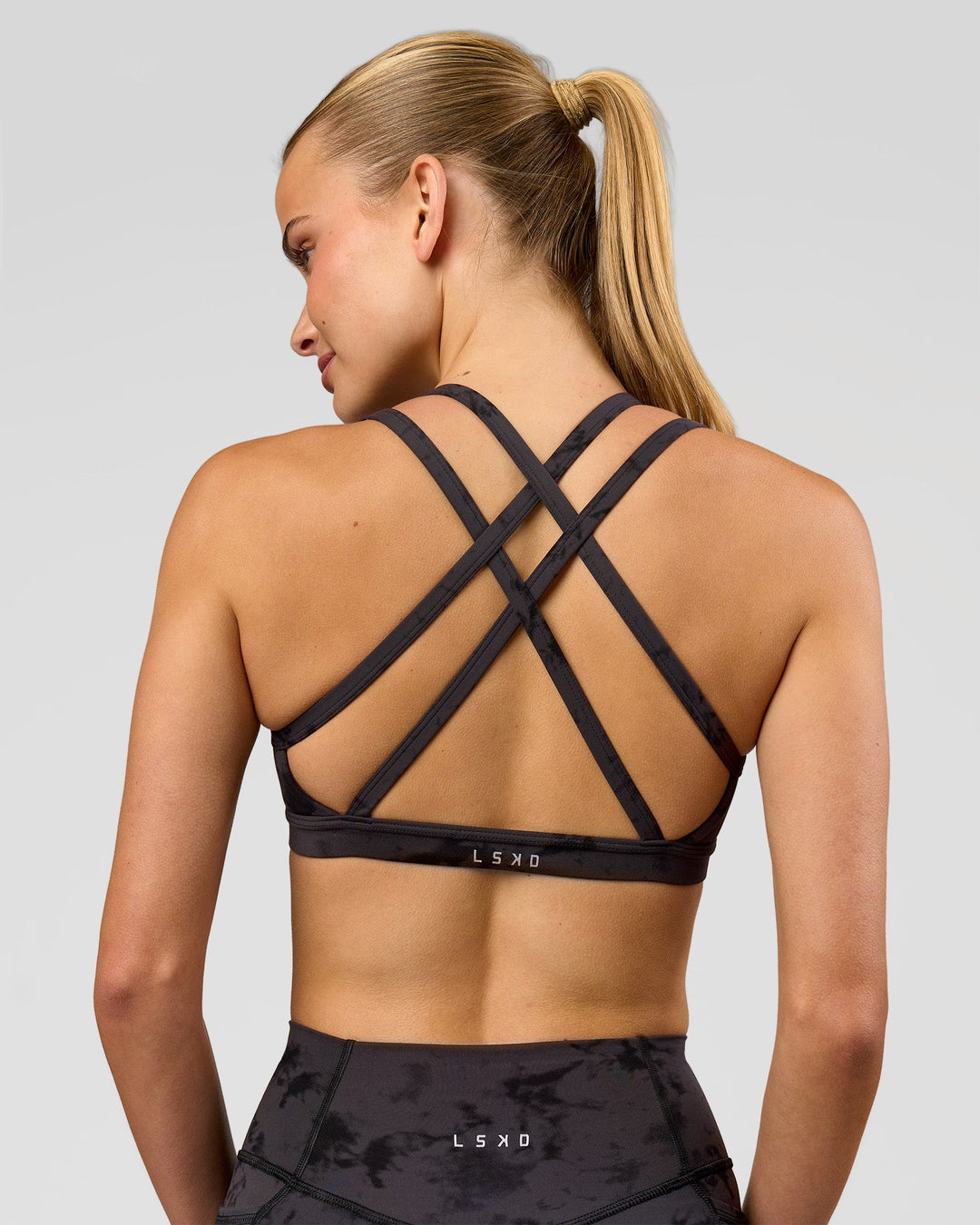Woman wearing Velocity Sports Bra - Black Tie Dye | Model:Taneisha | Size:XS - view 1
