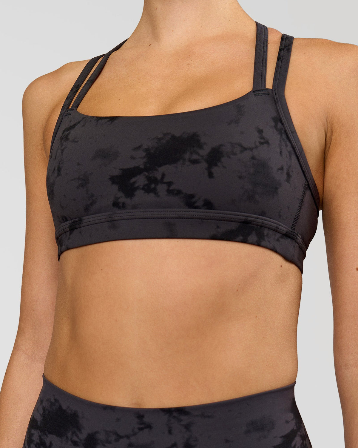Woman wearing Velocity Sports Bra - Black Tie Dye | Model:Taneisha | Size:XS
