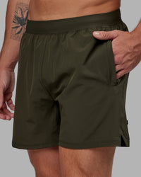 Man wearing Challenger 6" Lined Performance Short - Forest Night