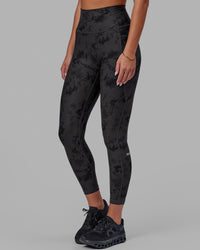 Woman wearing Fusion Ultra High-Rise 7/8 Legging Pockets - Black Tie-Dye | Model:Milly | Size:S
