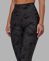 Woman wearing Fusion Ultra High-Rise 7/8 Legging Pockets - Black Tie-Dye | Model:Milly | Size:S