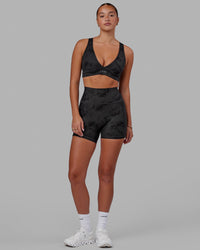 Woman wearing Fusion Ultra High-Rise 4" Short Pockets - Black Tie-Dye | Model:Milly | Size:S
