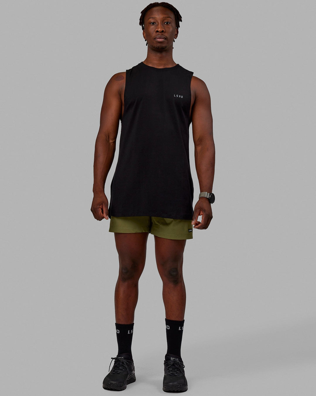 Man wearing Rep 5'' Performance Shorts - Moss