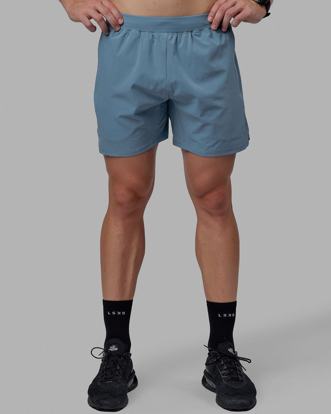 Man wearing Challenger 6" Lined Performance Shorts - Elemental Blue