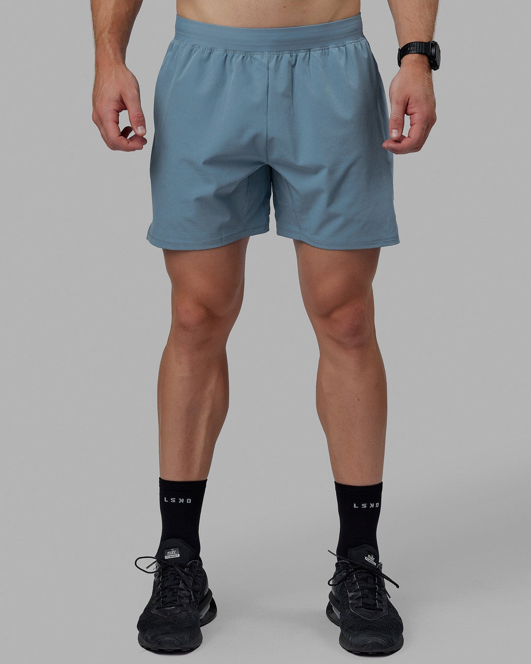 Man wearing Challenger 6" Performance Shorts - Elemental Blue