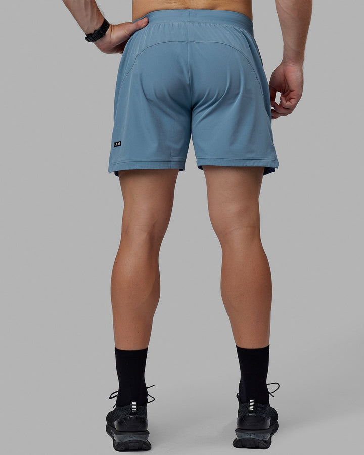 Man wearing Challenger 6" Performance Shorts - Elemental Blue