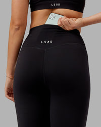 Woman wearing Elixir Ultra High-Rise 3/4 Legging - Black | Model:Chelsea | Size:S