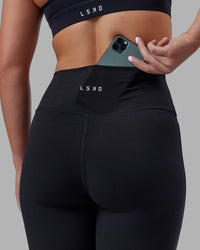 Woman wearing Fusion Ultra High-Rise Flared Petite Legging - Black| Model:Gracie | Size:S