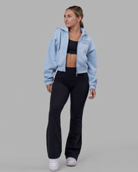 Woman wearing Fusion Ultra High-Rise Flared Petite Legging - Black| Model:Gracie | Size:S
