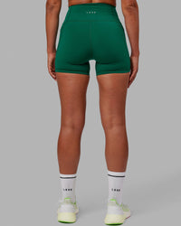Woman wearing Fusion Ultra High-Rise 4" Short Pockets - Malachite | Model:Sophie | Size:S