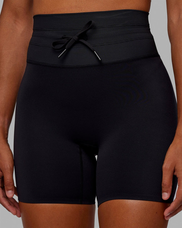 Woman wearing Resistance Mid-Length Shorts - Black
