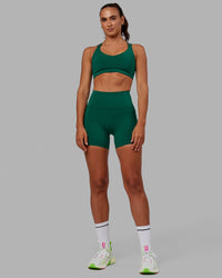 Woman wearing Fusion Ultra High-Rise 4" Short Pockets - Malachite | Model:Sophie | Size:S
